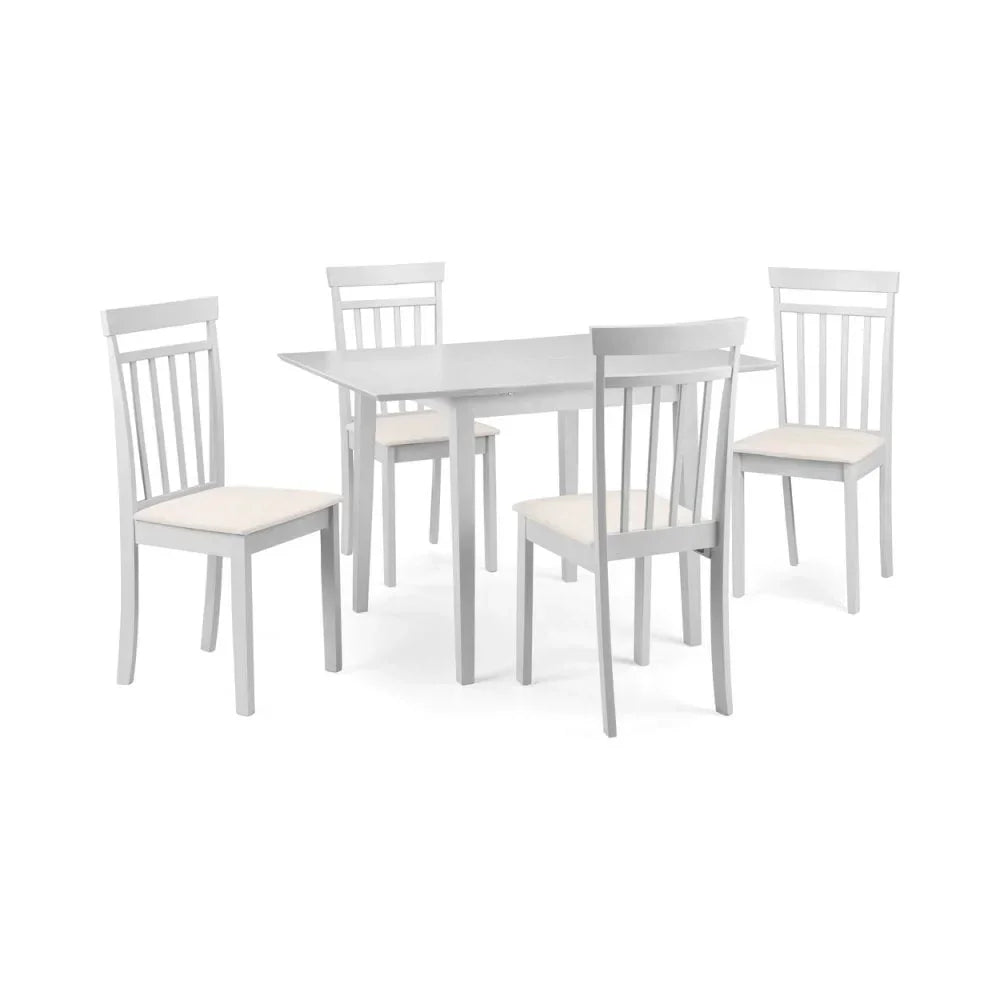 White dining table with four matching chairs featuring slatted backs and cushioned seats