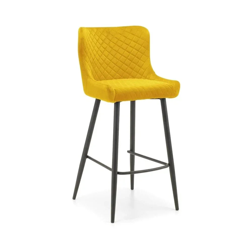 Yellow velvet bar stool with diamond-stitched backrest and black metal legs