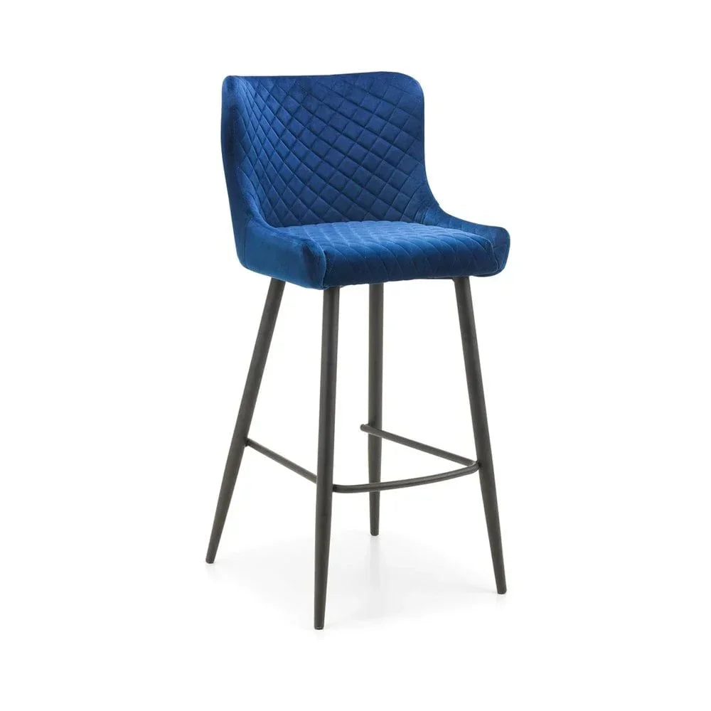 Blue velvet bar stool with diamond stitching and black metal legs on white background