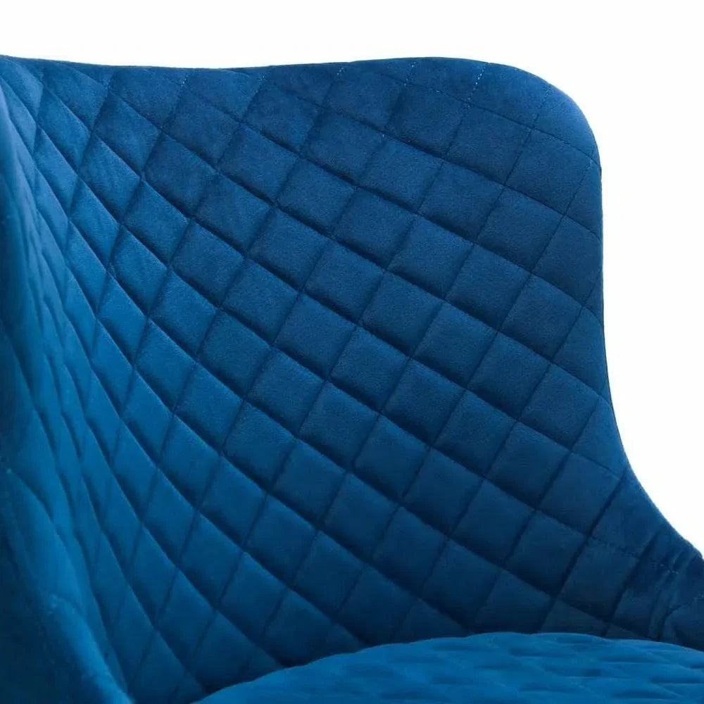 Blue velvet dining chair with diamond quilted backrest closeup