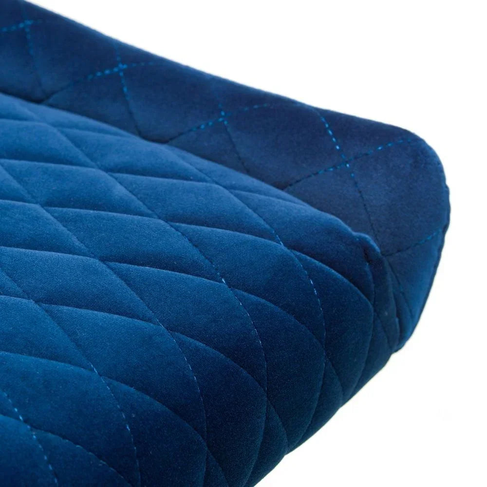 Close up of blue velvet dining chair seat with diamond quilted stitching detail