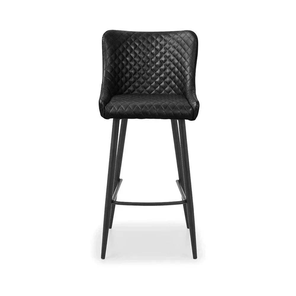 Black bar stool with quilted seat, padded backrest and slim tapered legs on white background