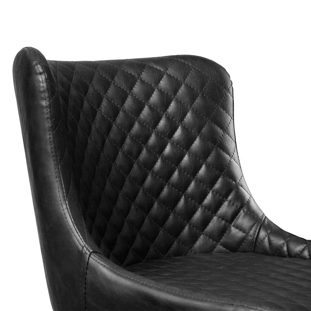 Closeup of black leather dining chair with diamond quilted stitching detail