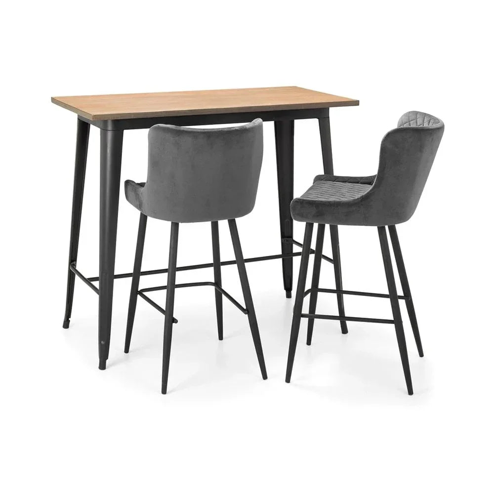 Bar table with light wood top and two grey velvet bar stools with black metal legs