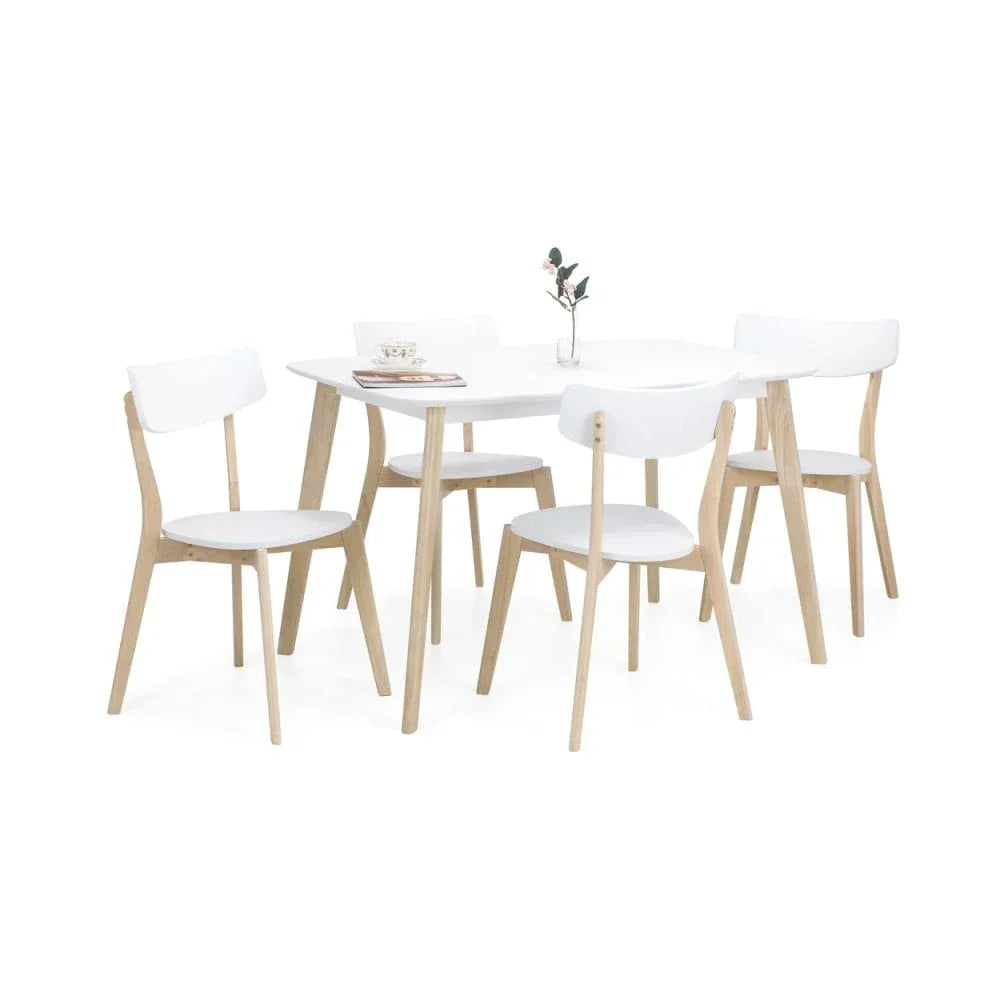 White dining table set with four chairs, wooden legs, and minimalist tabletop decor