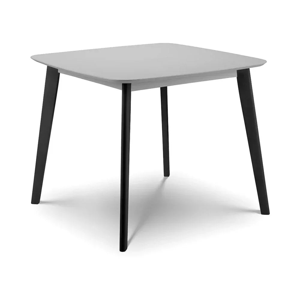 Square dining table with grey top and black angled legs on white background