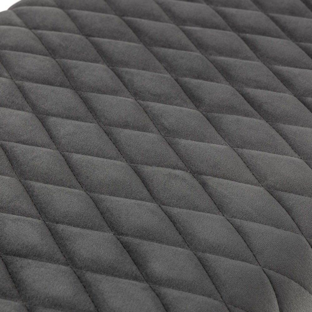 Close up of grey quilted sofa upholstery fabric with diamond pattern