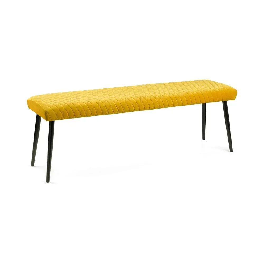 Yellow velvet dining bench with quilted seat and black metal legs, angled front view
