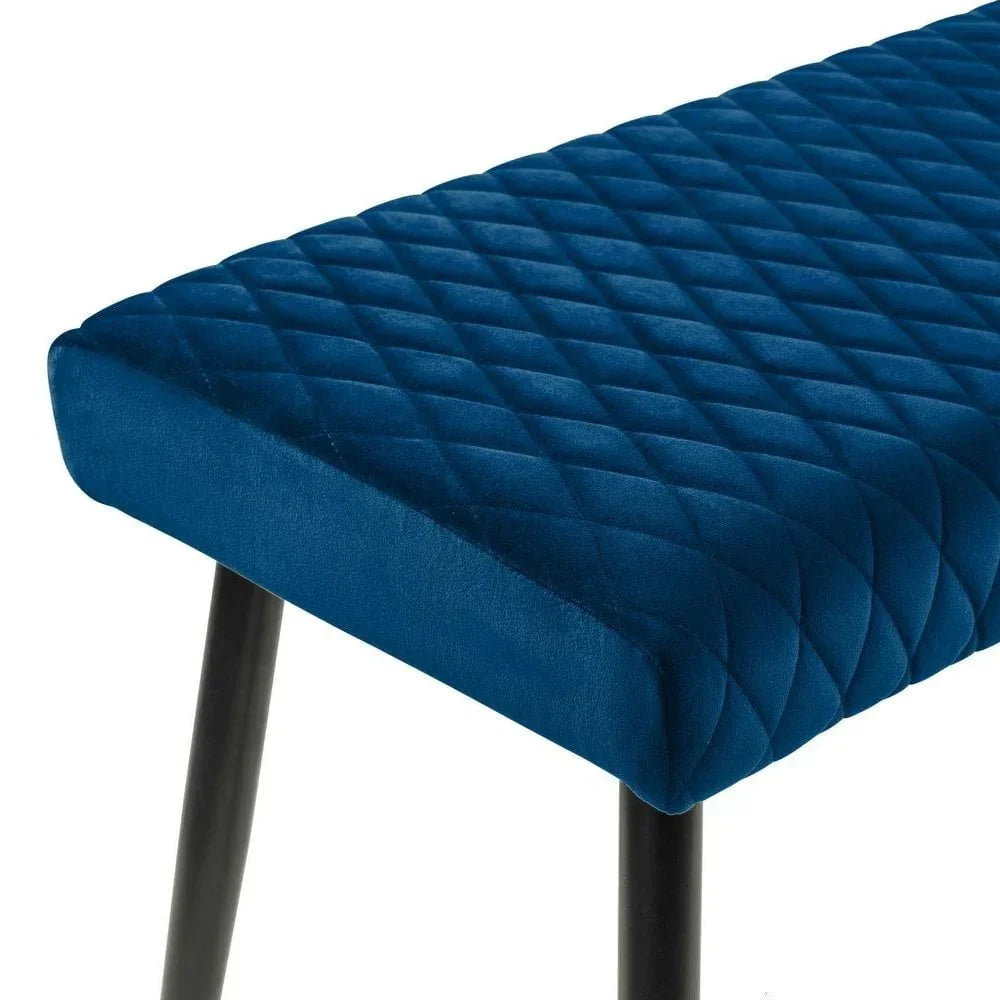 Blue velvet dining bench with diamond stitched cushion and black legs close up