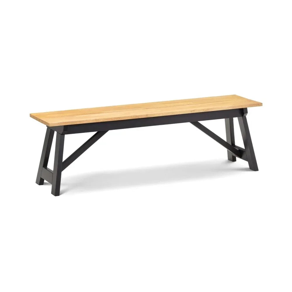 Wooden dining bench with black trestle legs and light oak seat, angled side view