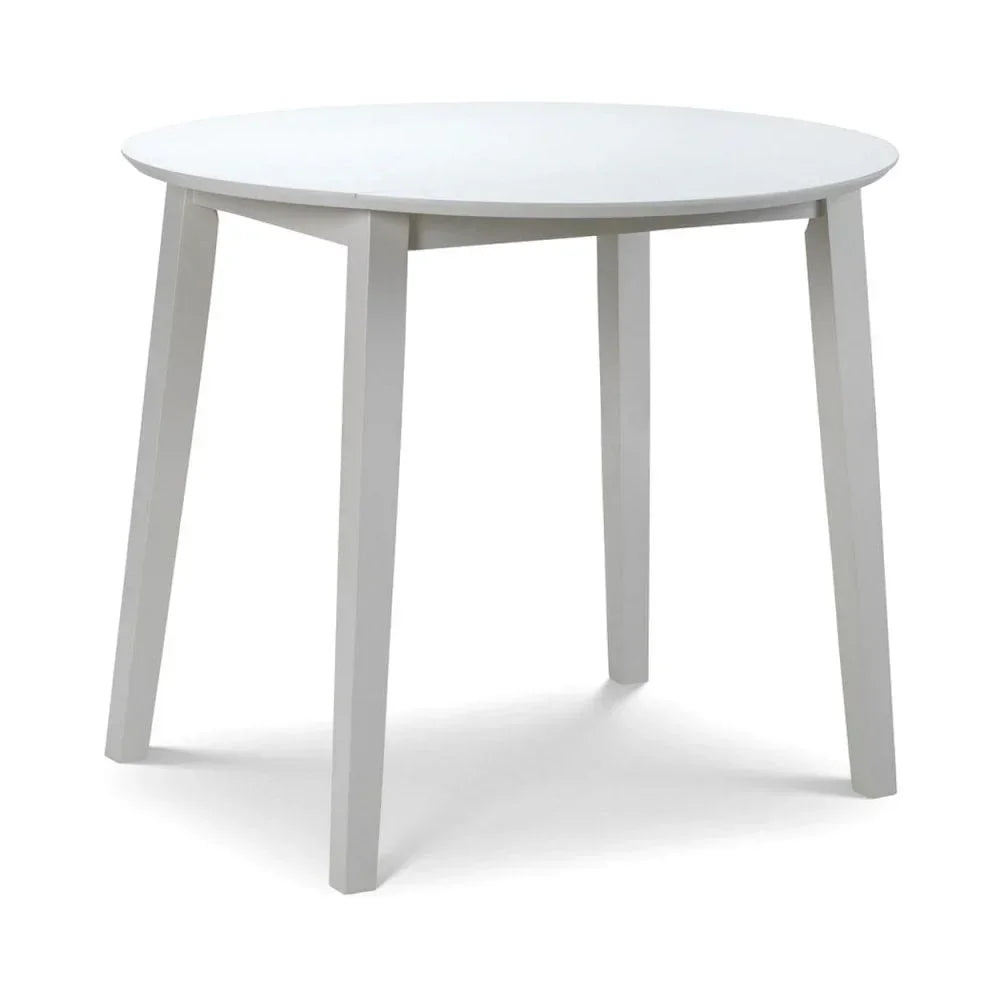 Round white dining table with four angled legs, modern minimalist design