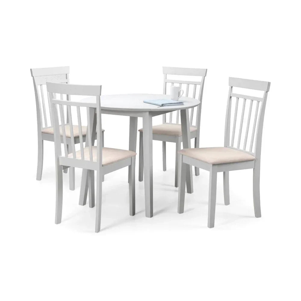 White wooden dining table set with round table and four slat back cushioned chairs