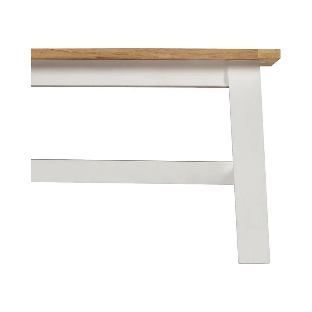 Close-up of wooden dining table with natural oak top and white painted legs