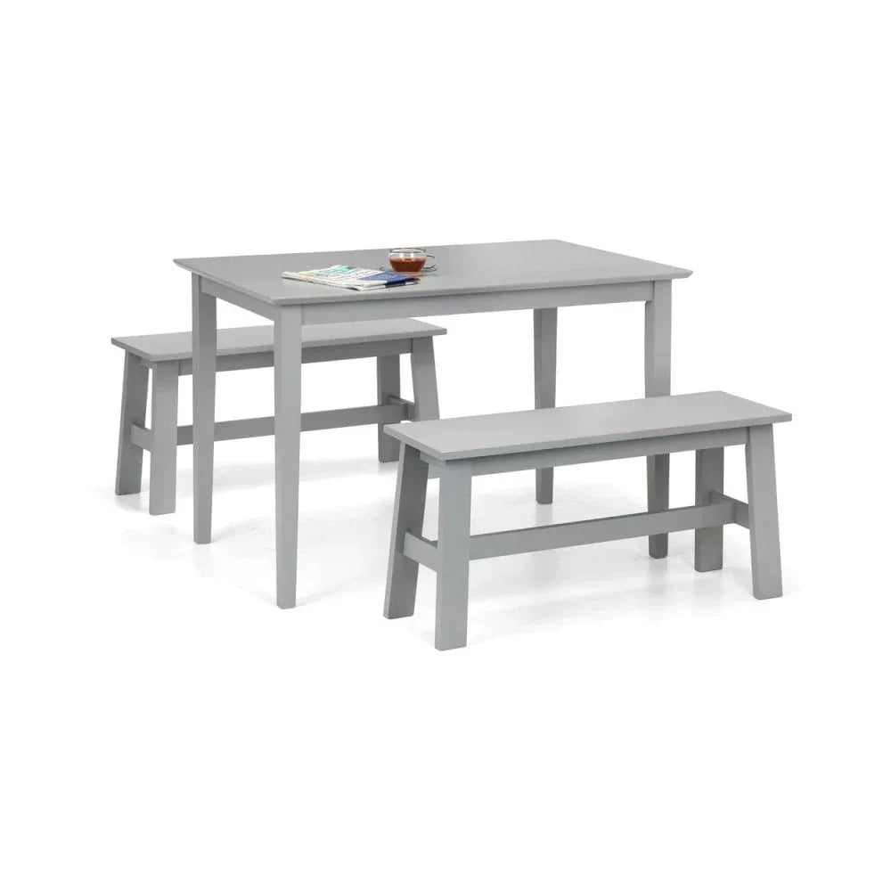 Grey wooden dining table set with two matching benches, tableware on tabletop