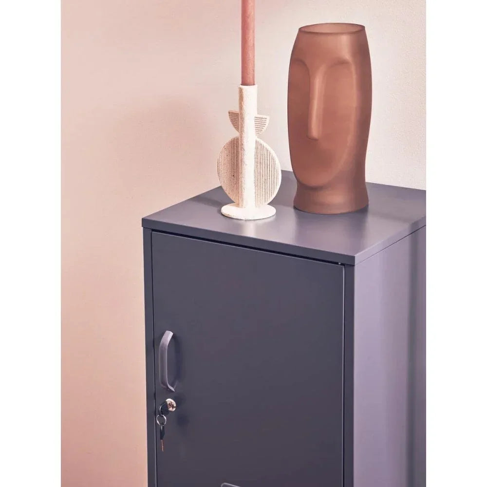 Grey metal storage cabinet with lock and display decor on top
