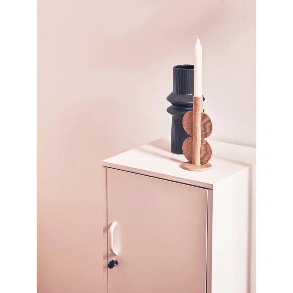 Modern side cabinet with black vase and wooden candle holder on top