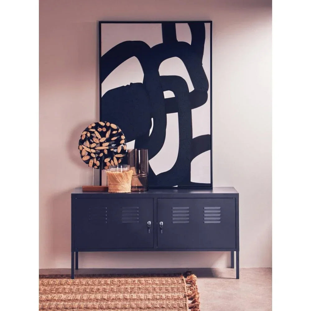 Black metal sideboard with modern abstract art and decorative accessories in hallway setting