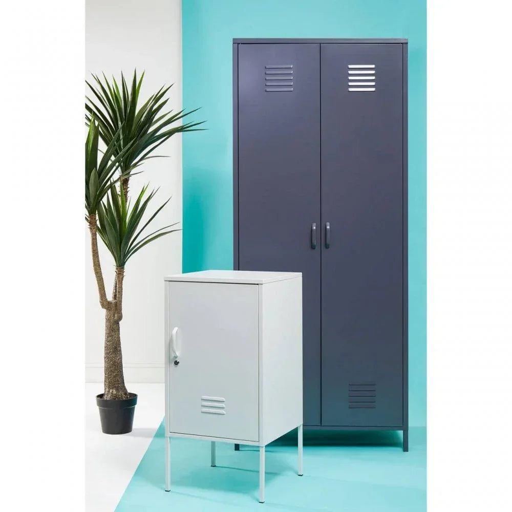 Tall navy metal storage cabinet and small white metal locker cabinet against turquoise wall