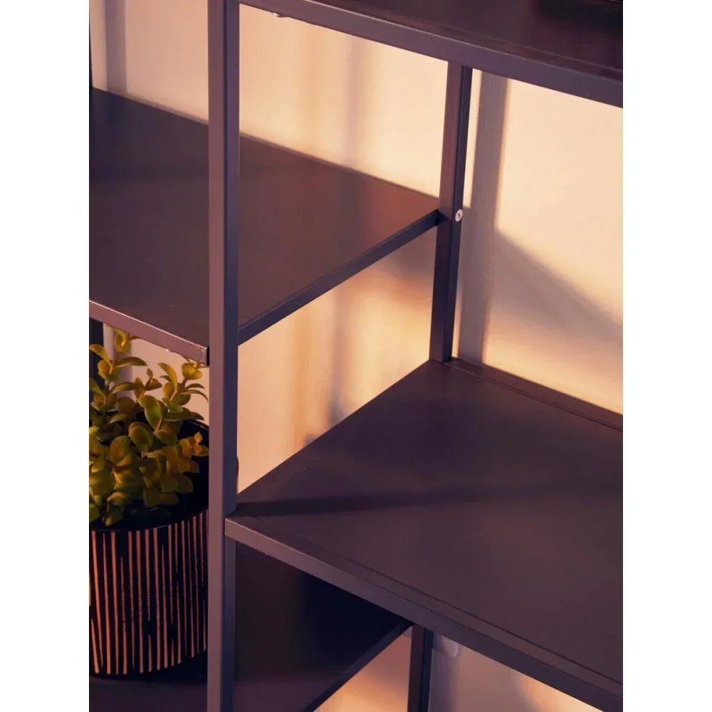 Black metal shelving unit with three shelves and potted plant on lower shelf