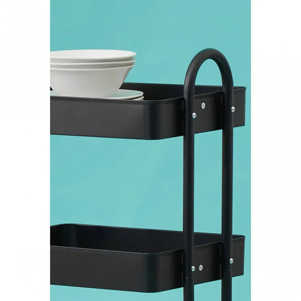 Black metal kitchen trolley with shelves and stacked white bowls on top shelf