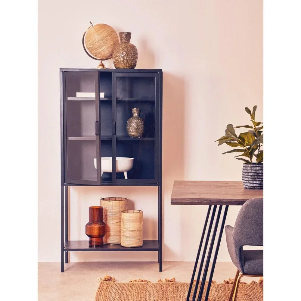 Black metal display cabinet with glass doors, decorative vases, and storage baskets