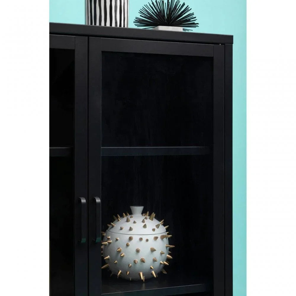 Black glass display cabinet with decorative spiked ceramic vase on interior shelf