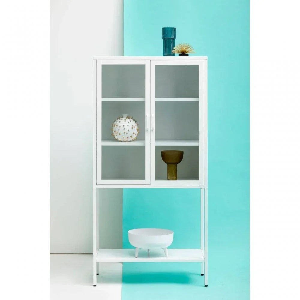 White metal display cabinet with glass doors and shelves, styled with modern decor pieces