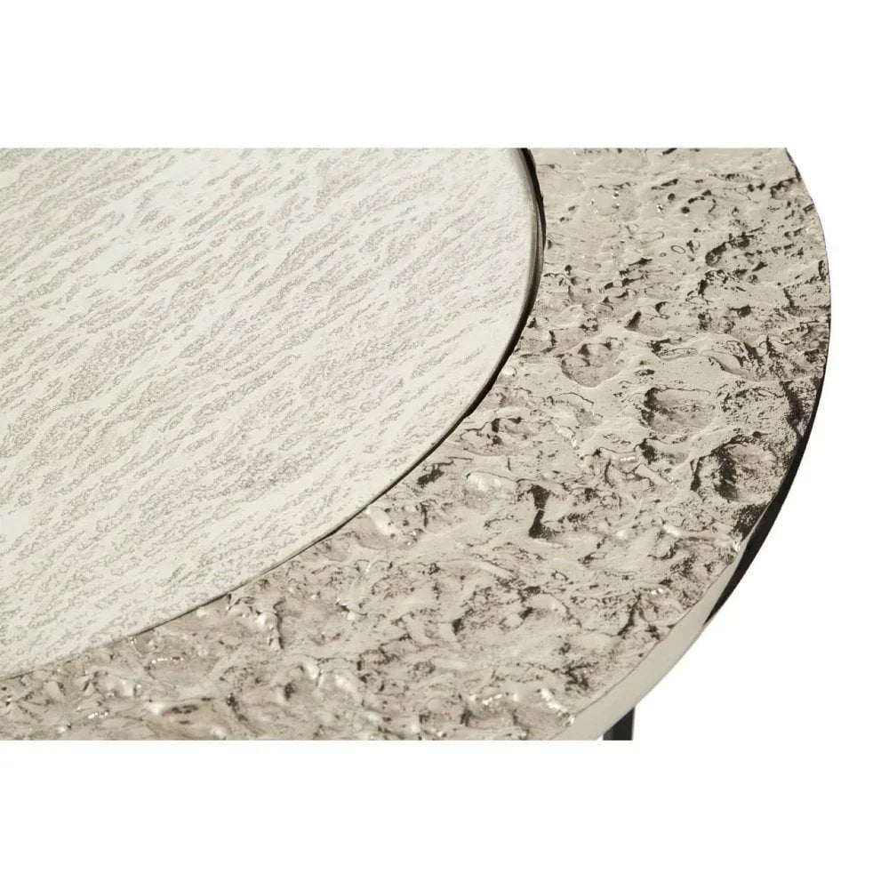 Round marble top coffee table with textured metallic edge close-up