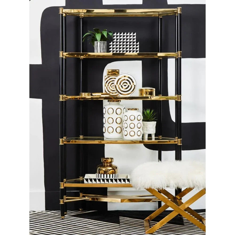 Gold and black shelving unit with decorative vases and plant, modern interior setting