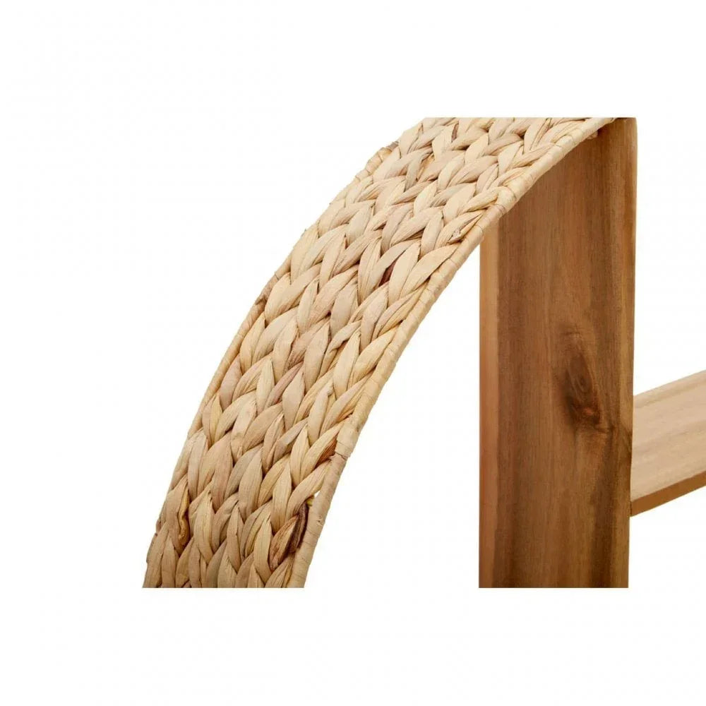 Close-up of woven rattan armrest and wooden frame detail on furniture piece