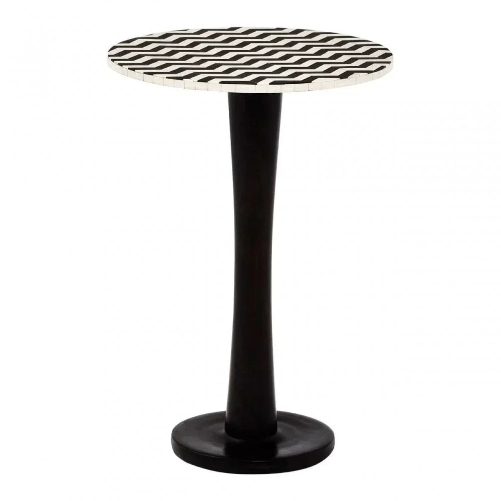 Black and white side table with geometric patterned round top and slender pedestal base