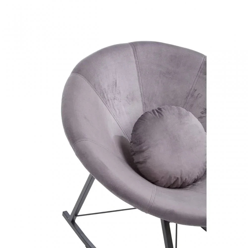 Grey velvet accent chair with round cushion and metal legs, close-up view