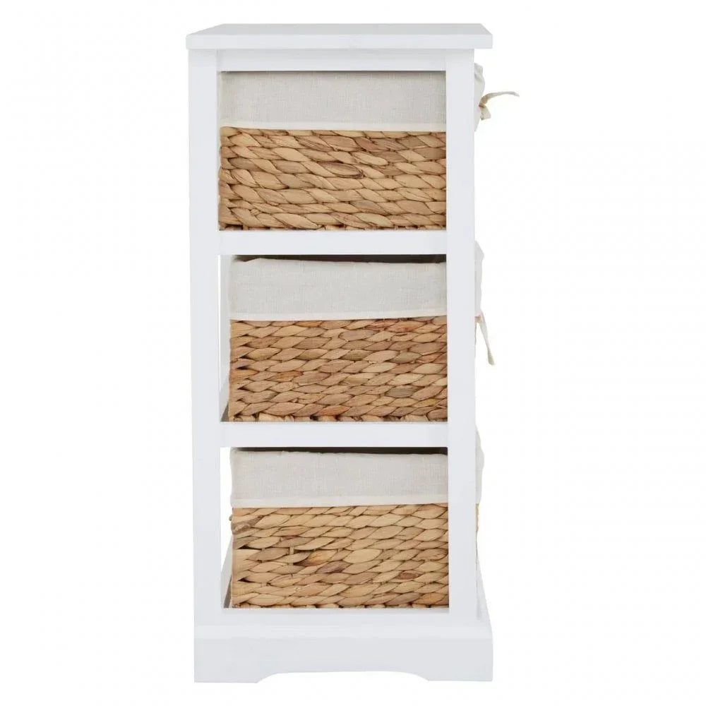 White wooden storage unit with three seagrass basket drawers and fabric linings