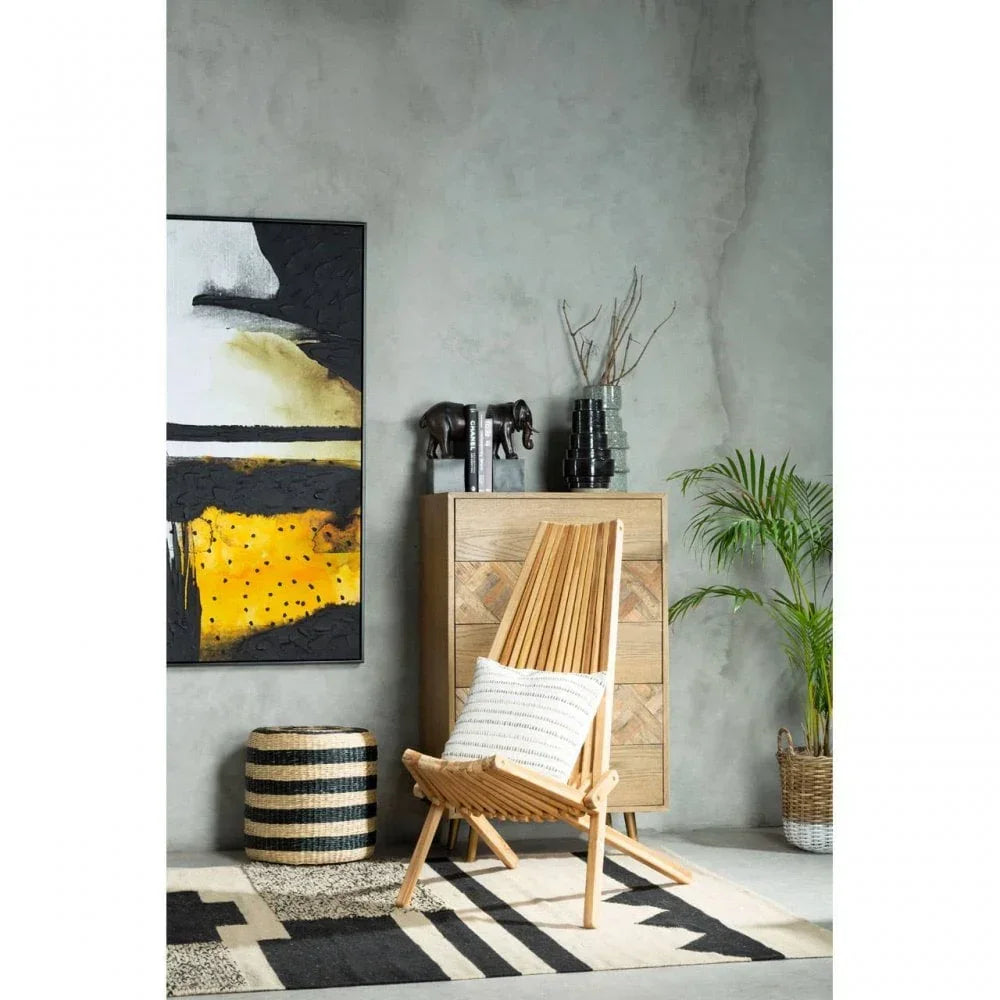 Modern wooden accent chair with cushion beside sideboard and abstract wall art