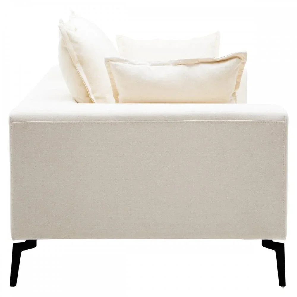 Side view of cream fabric sofa with slim black metal legs and plush cushions
