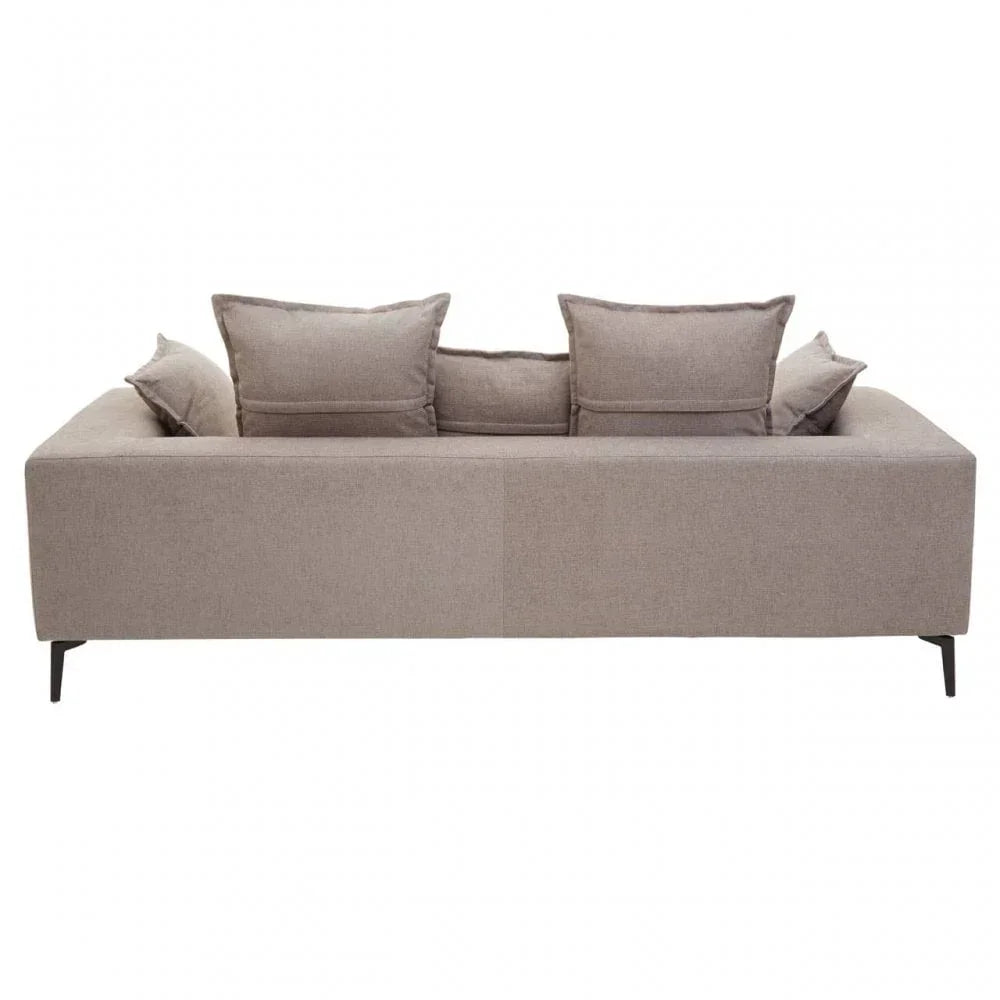 Rear view of beige fabric sofa with four cushions and slim black metal legs