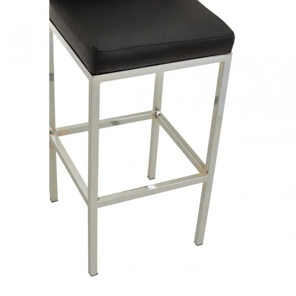 Black faux leather bar stool with chrome metal legs and footrest, side angle view