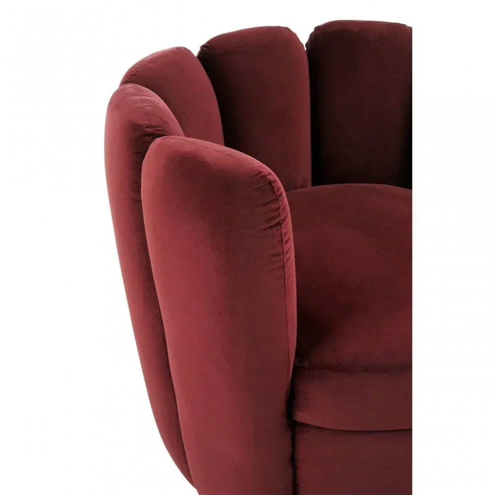 Close view of burgundy velvet armchair with scalloped backrest and plush padded seat