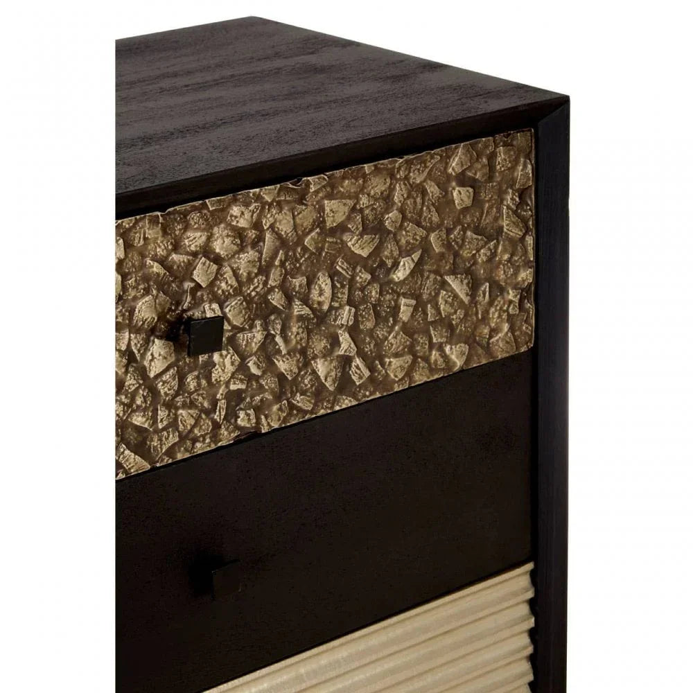 Textured gold and black chest of drawers corner with metallic detail and modern handles