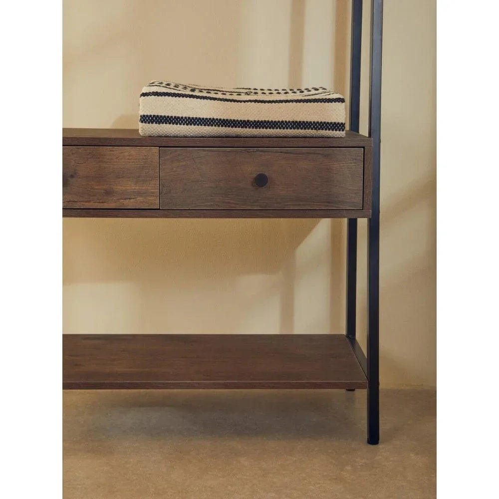 Wood console table with black metal frame, single drawer and shelf, folded striped throw on top