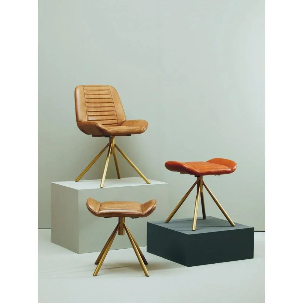 Tan leather accent chair and matching stools with gold metal legs on display stands