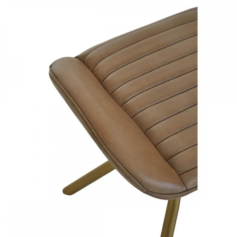Tan faux leather dining chair seat with stitched detail and gold metal legs, closeup view