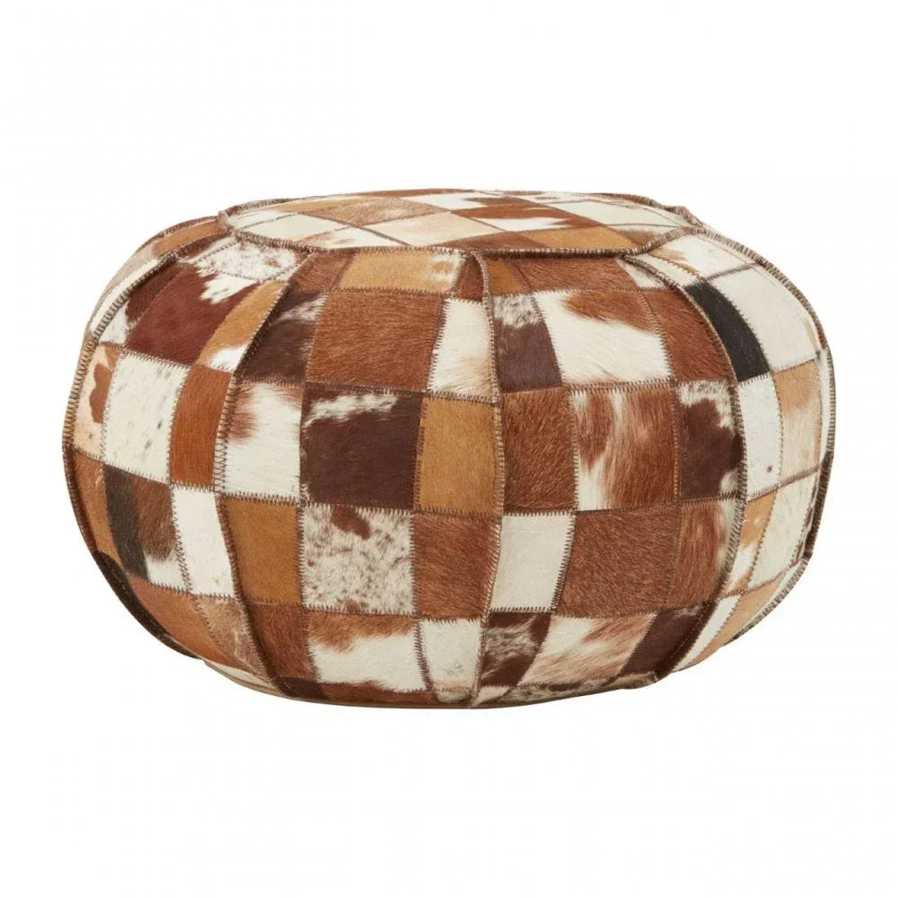 Brown and white cowhide pouffe ottoman with patchwork pattern and round shape