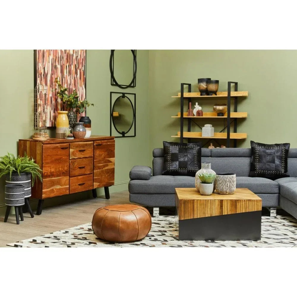 Modern living room with grey sofa, wood sideboard, leather pouffe, geometric coffee table
