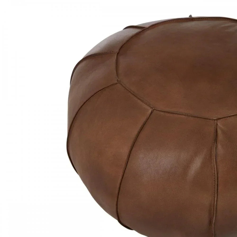 Brown leather pouffe footstool with stitched panels, close-up angled view