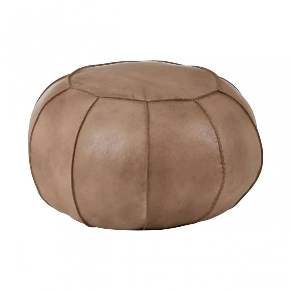 Round tan leather pouffe ottoman with stitched panel detail on white background