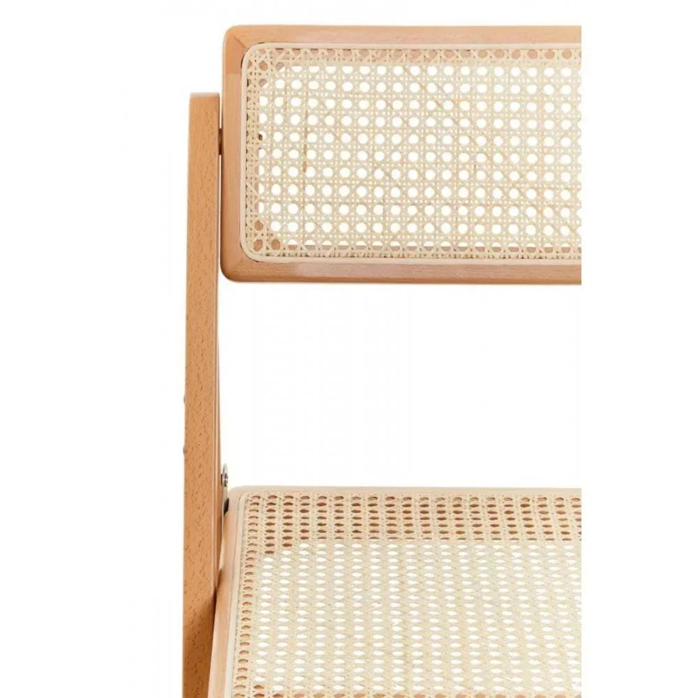 Closeup of wooden dining chair with woven rattan seat and backrest