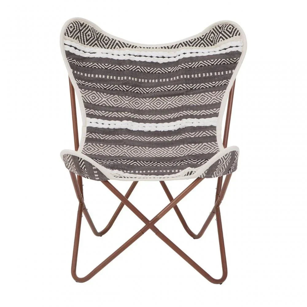 Patterned butterfly chair with black and white fabric seat and brown metal frame, front view