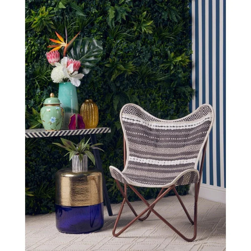 Patterned fabric accent chair with brown frame in modern living room setting