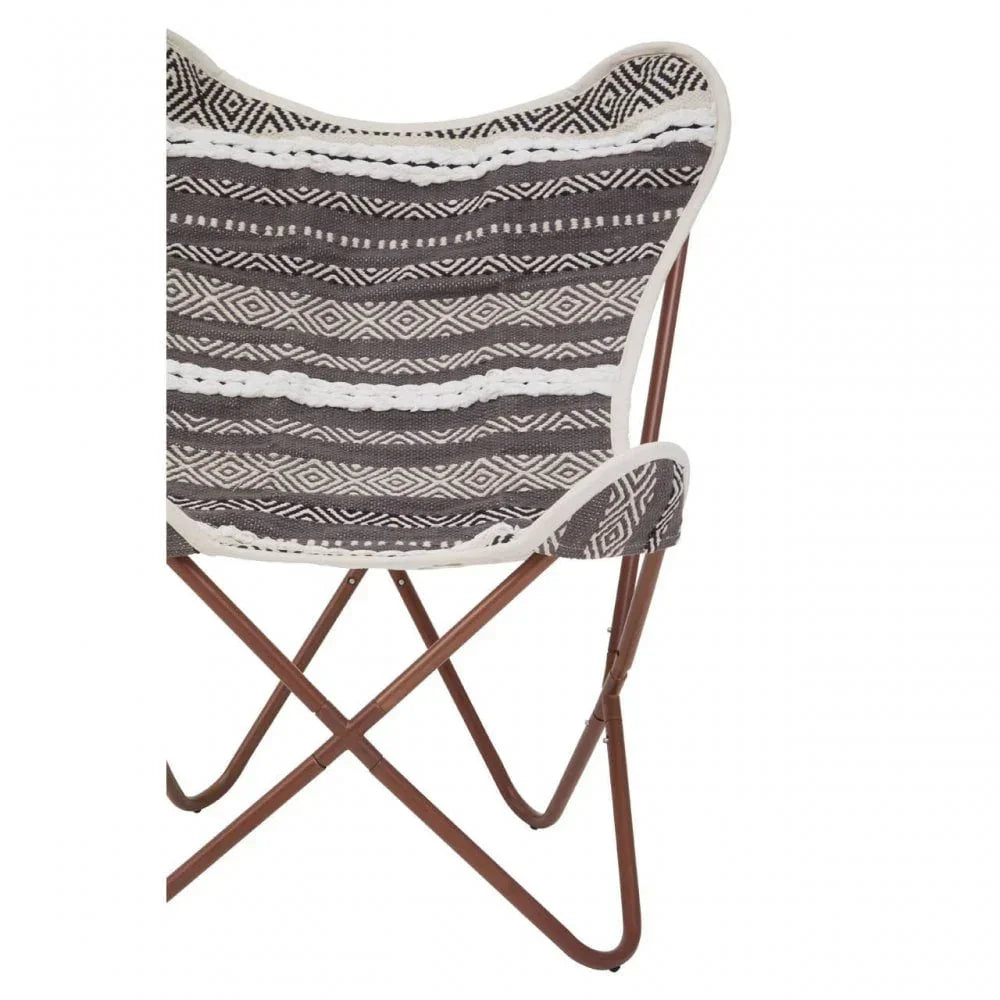 Black and white patterned butterfly chair with wooden frame, angled rear view